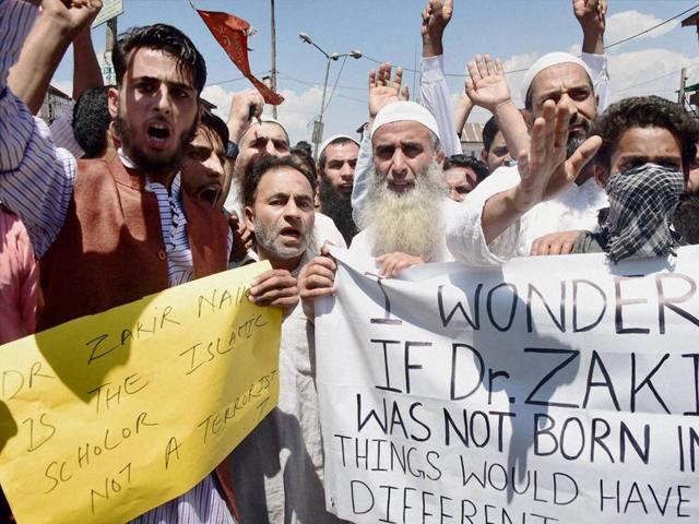 Supporters shout slogans and hold placards during a protest march in favour of Islamic scholar Zakir Naik in Srinagar on Friday. (PTI) Supporters shout slogans and hold placards during a protest march in favour of Islamic scholar Zakir Naik in Srinagar on Friday. (PTI)