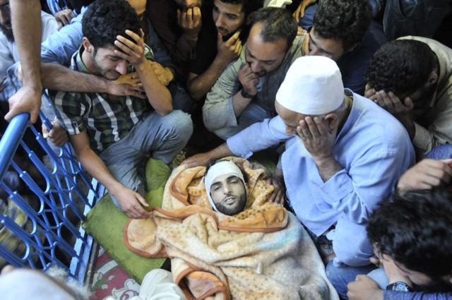 In Wani’s hometown of Tral, thousands of people sat with his body and funeral prayers are expected later in the day. (Waseem Andrabi/HT photo) In Wani’s hometown of Tral, thousands of people sat with his body and funeral prayers are expected later in the day. (Waseem Andrabi/HT photo)