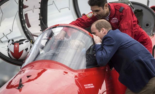 Prince George sits in the cockpit of a red arrows plane while wearing ear defenders against the roar of aircraft during a visit to the Royal international air tattoo at RAF Fairford, Britain. (Reuters) Prince George sits in the cockpit of a red arrows plane while wearing ear defenders against the roar of aircraft during a visit to the Royal international air tattoo at RAF Fairford, Britain. (Reuters)