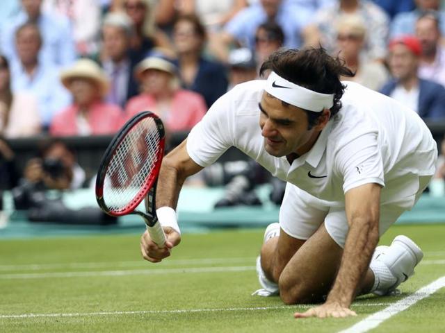 Roger Federer of Switzerland falls over during his men's semifinal. (AP Photo) 