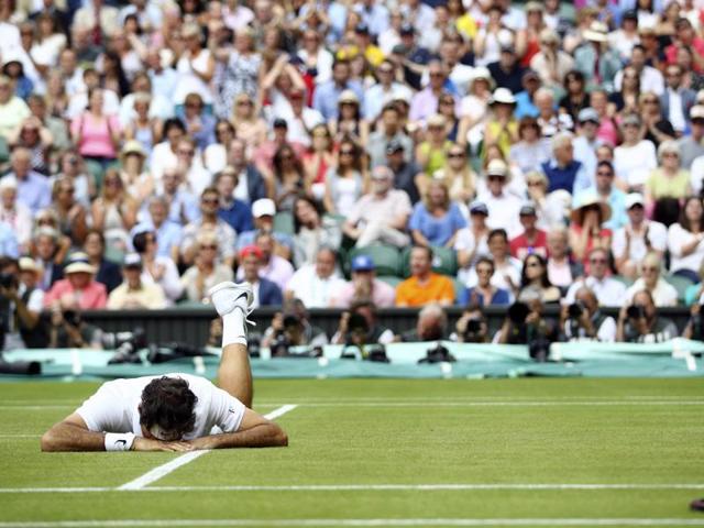Roger Federer of Switzerland falls over during his men's semifinal. (AP Photo) 