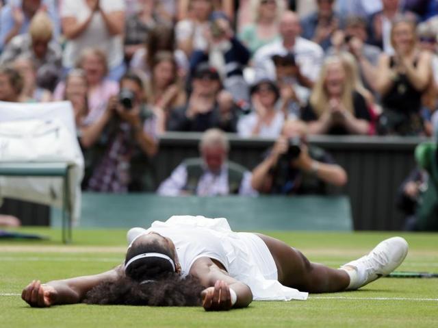 Serena lies flat on the grass in celebration of her win. (AP) Serena lies flat on the grass in celebration of her win. (AP)
