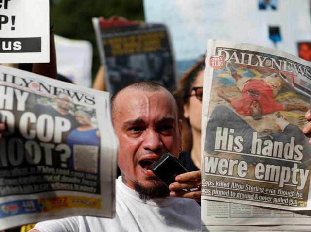 A man shows newspapers as people take part in a protest against the killings of Alton Sterling and Philando Castile during a march in New York. (REUTERS) A man shows newspapers as people take part in a protest against the killings of Alton Sterling and Philando Castile during a march in New York. (REUTERS)