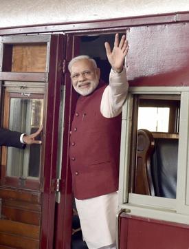 Prime Minister Narendra Modi waves from a train at Pietermaritzburg railway station on Saturday. (PTI Photo)