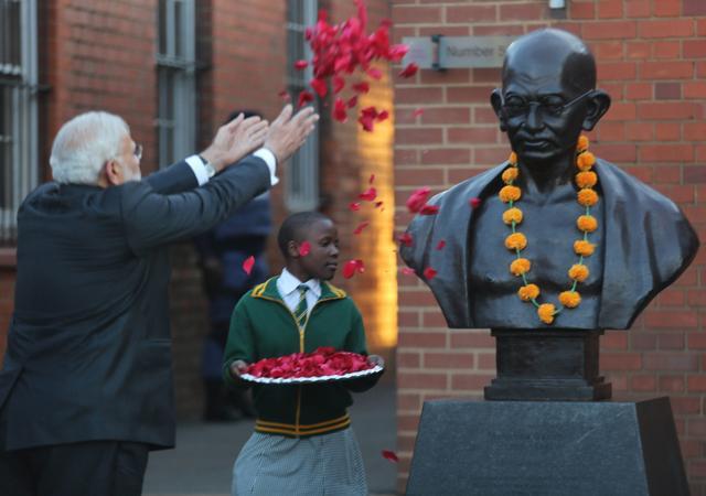 Prime Minister Narendra Modi throws petals to pay tributes to Mahatma Gandhi on a visit to Constitutional Hill in Johannesburg. (PTI) Prime Minister Narendra Modi throws petals to pay tributes to Mahatma Gandhi on a visit to Constitutional Hill in Johannesburg. (PTI)