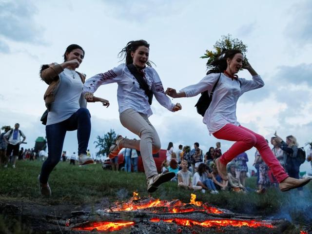 People jump over a camp fire during the celebration. (REUTERS) People jump over a camp fire during the celebration. (REUTERS)