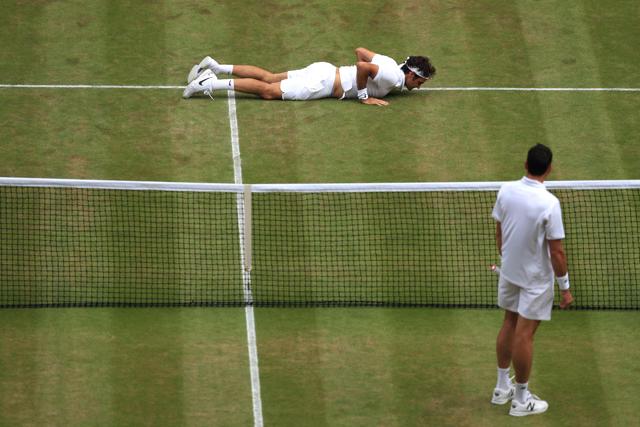 Switzerland's Roger Federer falls to the ground while trying to return to Canada's Milos Raonic. (AFP) Switzerland's Roger Federer falls to the ground while trying to return to Canada's Milos Raonic. (AFP)