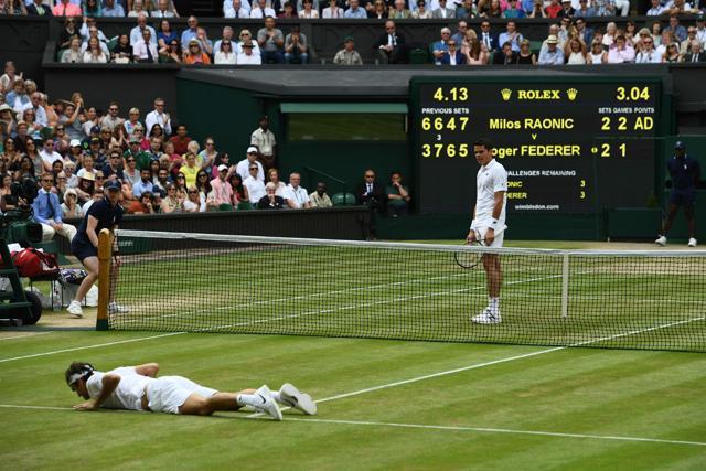 Switzerland's Roger Federer lies on court after falling while trying to return to Canada's Milos Raonic. (AFP Photo) Switzerland's Roger Federer lies on court after falling while trying to return to Canada's Milos Raonic. (AFP Photo)