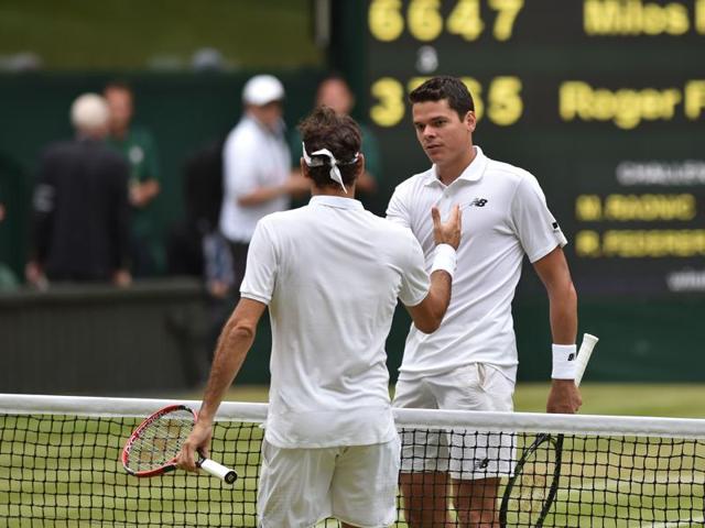 Canada's Milos Raonic (R) shakes hands with Switzerland's Roger Federer after winning their men's semifinal. (AFP Photo) 