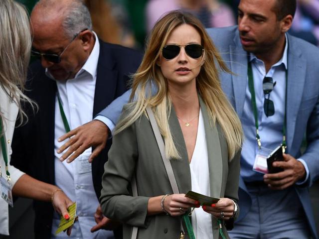 Czech model Ester Satorova, wife of Czech Republic's Tomas Berdych, arrives on centre court to watch the men's singles semifinal. (AFP Photo) 