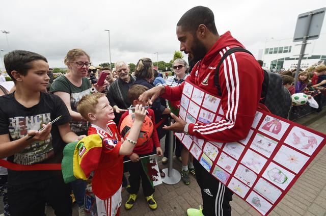 Wales' Ashley Williams signs autographs for fans as he arrives at Cardiff airport. (Reuters Photo) Wales' Ashley Williams signs autographs for fans as he arrives at Cardiff airport. (Reuters Photo)