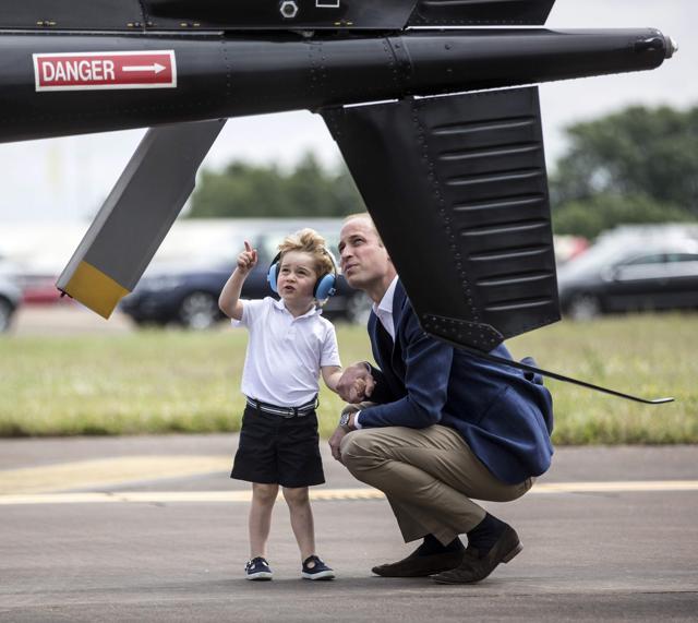 Prince George looks up at the tail rotor of a "Squirrel" helicopter similar to the one that his father Prince william trained on as he visits the Royal international air tattoo at RAF Fairford, Britain. (Reuters) Prince George looks up at the tail rotor of a "Squirrel" helicopter similar to the one that his father Prince william trained on as he visits the Royal international air tattoo at RAF Fairford, Britain. (Reuters)