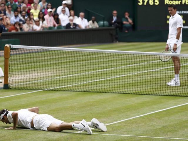 Canada's Milos Raonic looks on after Switzerland's Roger Federer fell during their match. (REUTERS) 
