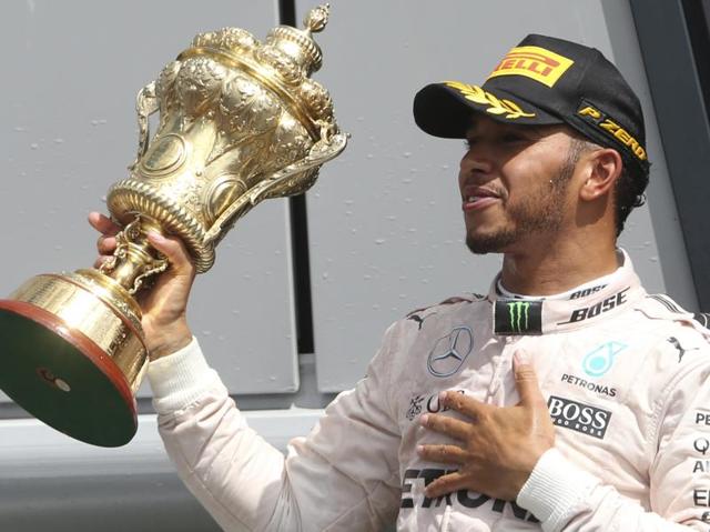 Mercedes driver Lewis Hamilton of Britain holds the trophy on the podium after winning the British GP. (AP Photo) Mercedes driver Lewis Hamilton of Britain holds the trophy on the podium after winning the British GP. (AP Photo)