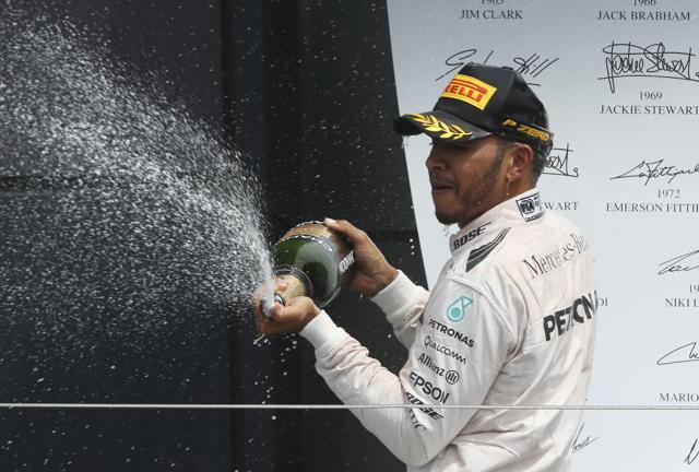 Mercedes driver Lewis Hamilton of Britain, sprays champagne on the podium. (AP Photo) Mercedes driver Lewis Hamilton of Britain, sprays champagne on the podium. (AP Photo)