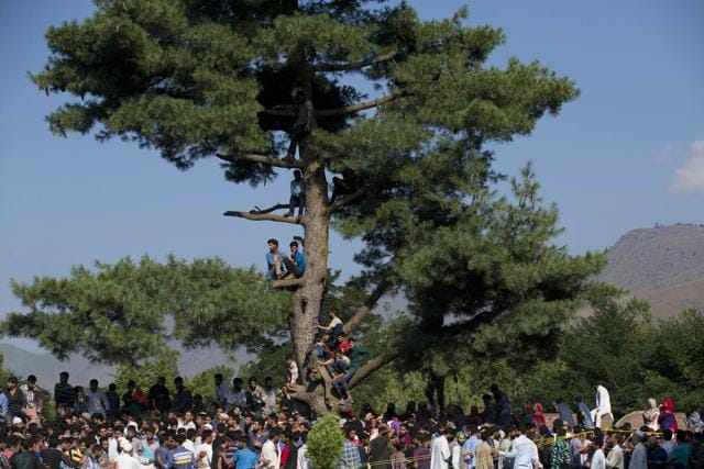 Kashmiri villagers watch the funeral of Burhan Wani, chief of operations of Kashmir's largest rebel group Hizbul Mujahideen, in Tral, some 38 Kilometers (24 miles) south of Srinagar. (AP)