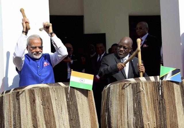 Prime Minister Narendra Modi and his host, Tanzanian President John Pombe Magufuli, play drums at the entrance of State House during an official welcome ceremony in Dar es Salaam on Sunday. (PTI Photo) Prime Minister Narendra Modi and his host, Tanzanian President John Pombe Magufuli, play drums at the entrance of State House during an official welcome ceremony in Dar es Salaam on Sunday. (PTI Photo)