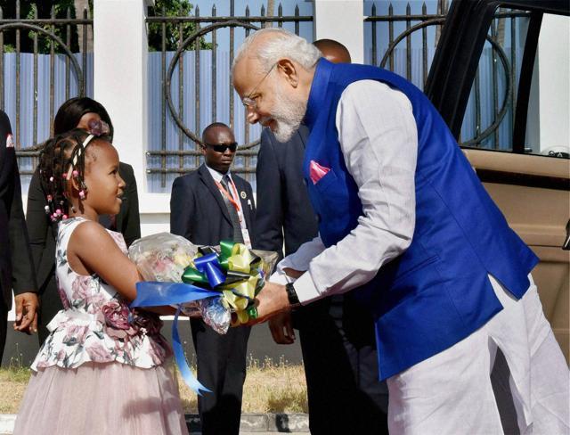 Prime Minister Narendra Modi is greeted by a kid during a ceremonial welcome in Dar-es-Salaam, Tanzania, on Sunday. (PTI Photo) Prime Minister Narendra Modi is greeted by a kid during a ceremonial welcome in Dar-es-Salaam, Tanzania, on Sunday. (PTI Photo)