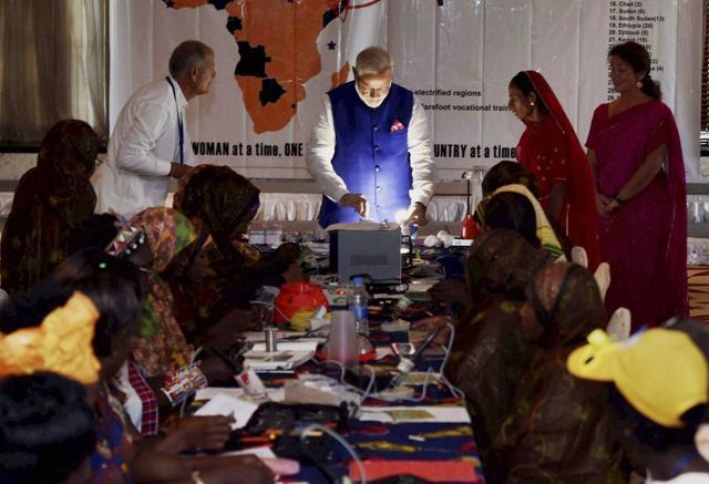 Prime Minister Narendra Modi takes a look at solar-powered equipment during a visit to the Barefoot College and ‘Solar Mamas’ in Dar-es-Salaam on Sunday. (PTI Photo) Prime Minister Narendra Modi takes a look at solar-powered equipment during a visit to the Barefoot College and ‘Solar Mamas’ in Dar-es-Salaam on Sunday. (PTI Photo)