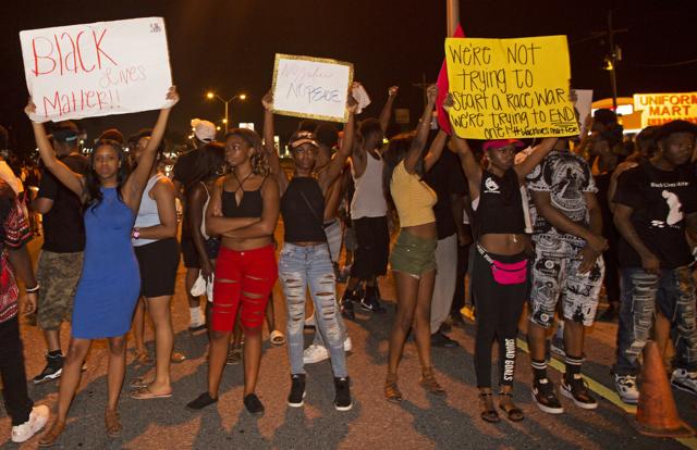Protesters block Airline Highway, a major road that passes in front of the Baton Rouge Police Department headquarters. (AP) Protesters block Airline Highway, a major road that passes in front of the Baton Rouge Police Department headquarters. (AP)