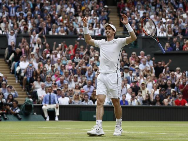 Murray drops his racquet and looks to his box in celebration. (REUTERS)