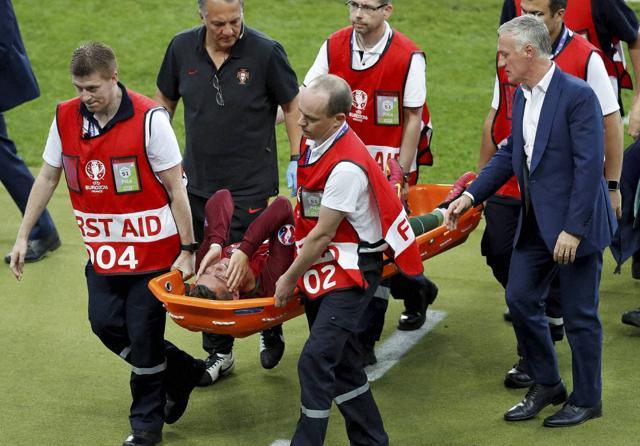 France coach Didier Deschamps (right) looks after Portugal's Cristiano Ronaldo who suffered an injury during the Euro 2016 final match between Portugal and France at the Stade de France in Saint-Denis. (AP Photo) France coach Didier Deschamps (right) looks after Portugal's Cristiano Ronaldo who suffered an injury during the Euro 2016 final match between Portugal and France at the Stade de France in Saint-Denis. (AP Photo)
