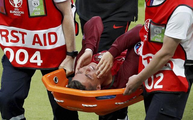 Portugal's Cristiano Ronaldo covers his face as he is stretchered off the pitch after suffering an injury. (AP Photo) Portugal's Cristiano Ronaldo covers his face as he is stretchered off the pitch after suffering an injury. (AP Photo)