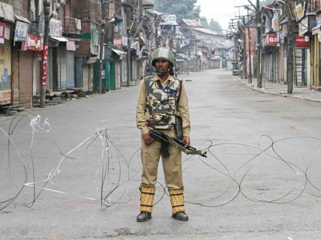 A paramilitary soldier stands guard during a curfew in Srinagar. (Waseem Andrabi / HT PHOTO) A paramilitary soldier stands guard during a curfew in Srinagar. (Waseem Andrabi / HT PHOTO)