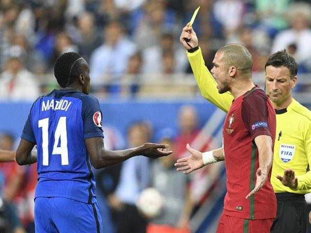 English referee Mark Clattenburg shows a yellow card as France's midfielder Blaise Matuidi and Portugal's defender Pepe react during the Euro 2016 final. (AFP Photo) English referee Mark Clattenburg shows a yellow card as France's midfielder Blaise Matuidi and Portugal's defender Pepe react during the Euro 2016 final. (AFP Photo)