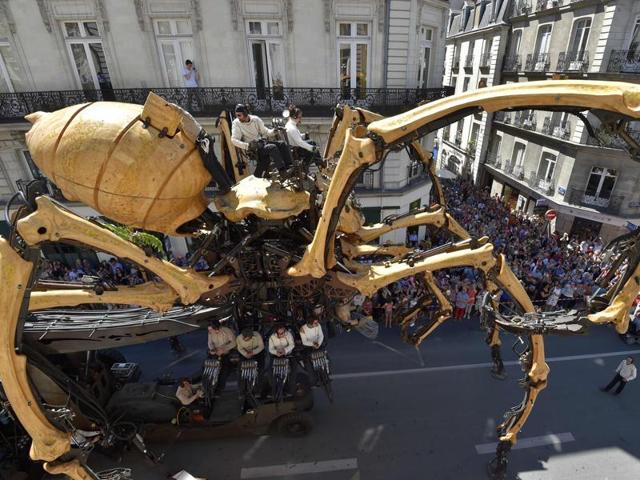 Men ride Kumo, a mechanical spider made of wood and steel by Les Machines de L'Ile (Machines of the Isle of Nantes) factory, in the streets of Nantes, during its first presentation to the public. (AFP) Men ride Kumo, a mechanical spider made of wood and steel by Les Machines de L'Ile (Machines of the Isle of Nantes) factory, in the streets of Nantes, during its first presentation to the public. (AFP)