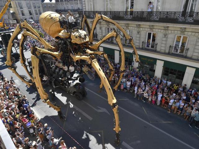 Crowds gather at the first public presentation of Kumo, a mechanical spider made by Les Machines de L'Ile (Machines of the Isle of Nantes) factory, in the streets of Nantes. (AFP) Crowds gather at the first public presentation of Kumo, a mechanical spider made by Les Machines de L'Ile (Machines of the Isle of Nantes) factory, in the streets of Nantes. (AFP)