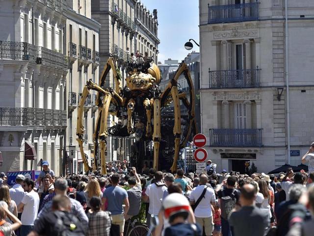 People are awestruck at Kumo, a mechanical spider made of wood and steel presented to the public for the first time in the streets of Nantes, western France. (AFP) People are awestruck at Kumo, a mechanical spider made of wood and steel presented to the public for the first time in the streets of Nantes, western France. (AFP)
