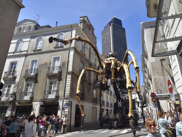 Kumo, a mechanical spider made of wood and steel towers over the crowd in western France. (AFP) Kumo, a mechanical spider made of wood and steel towers over the crowd in western France. (AFP)
