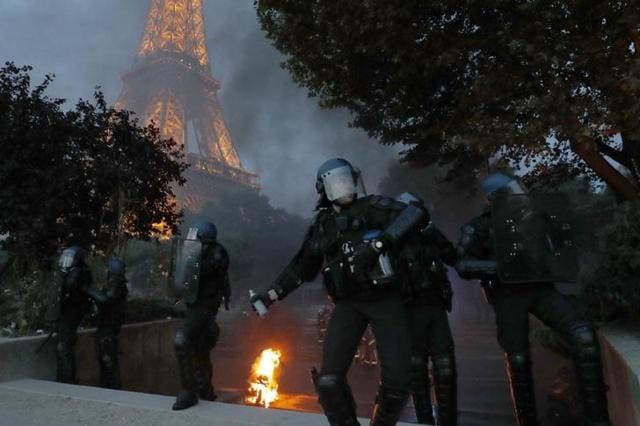French riot police react with tear gas during clashes near the Eiffel Tower at the Paris fan zone. (Reuters)