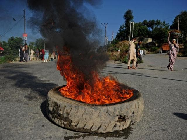 A tyre burns on a national highway during a curfew in Srinagar. Clashes spread across Kashmi as protesters angry at the killing on July 8 of Hizbul Mujahideen militant leader Burhan Wani torched police stations and threw rocks at army camps in the south of Kashmir. (AFP) A tyre burns on a national highway during a curfew in Srinagar. Clashes spread across Kashmi as protesters angry at the killing on July 8 of Hizbul Mujahideen militant leader Burhan Wani torched police stations and threw rocks at army camps in the south of Kashmir. (AFP)