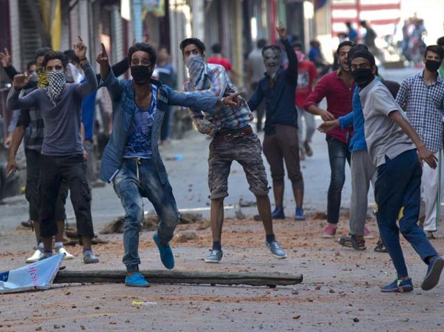 Protesters taunt Indian policemen as they clash in Srinagar. Authorities were struggling Monday to contain protests by Kashmiris angry after several people were killed in weekend demonstrations, as youths defied a curfew to rally in the streets against the killing of a militant leader Burhan Wani. (AP) Protesters taunt Indian policemen as they clash in Srinagar. Authorities were struggling Monday to contain protests by Kashmiris angry after several people were killed in weekend demonstrations, as youths defied a curfew to rally in the streets against the killing of a militant leader Burhan Wani. (AP)