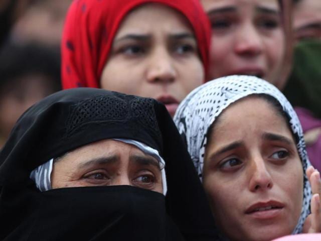 Villagers watch the funeral procession of Burhan Wani, a leader of Hizbul Mujahideen, Kashmir’s largest militant group , in Tral. Troops fired on protesters in Kashmir as tens of thousands of people defied a curfew imposed in most parts of the region. (AP) Villagers watch the funeral procession of Burhan Wani, a leader of Hizbul Mujahideen, Kashmir’s largest militant group , in Tral. Troops fired on protesters in Kashmir as tens of thousands of people defied a curfew imposed in most parts of the region. (AP)