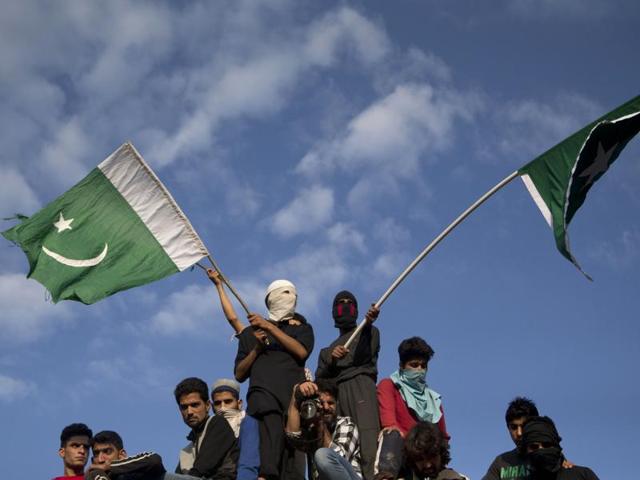 Villagers wave Pakistani flags during the funeral procession of Burhan Wani in Tral. (AP) Villagers wave Pakistani flags during the funeral procession of Burhan Wani in Tral. (AP)