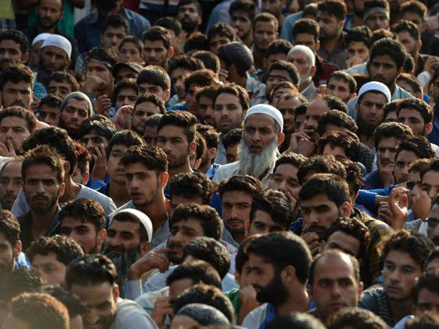 Kashmiri mourners look on near the body of Burhan Wani during his funeral in Tral. Wani was a top figure in Hizbul Mujahideen and had a Rs 10-lakh bounty on his head. (AFP) Kashmiri mourners look on near the body of Burhan Wani during his funeral in Tral. Wani was a top figure in Hizbul Mujahideen and had a Rs 10-lakh bounty on his head. (AFP)