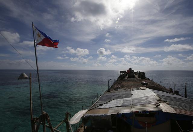In this photo taken March 29, 2014, a Philippine flag flutters from the deck of the Philippine Navy ship LT 57 Sierra Madre off Second Thomas Shoal in the South China Sea. (AP) In this photo taken March 29, 2014, a Philippine flag flutters from the deck of the Philippine Navy ship LT 57 Sierra Madre off Second Thomas Shoal in the South China Sea. (AP)