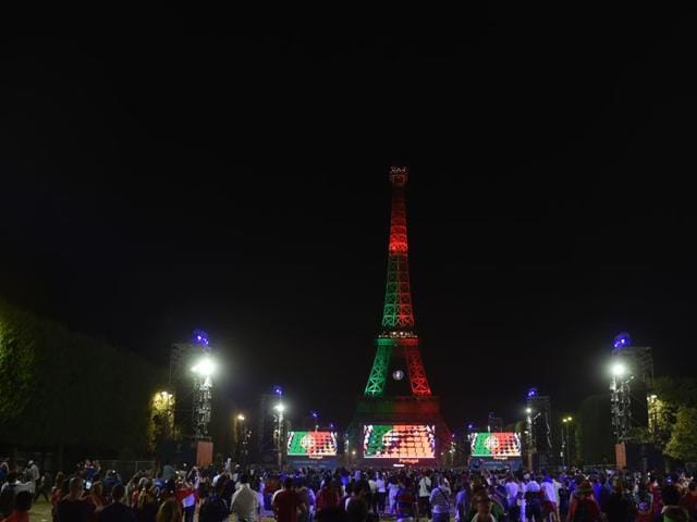 The Eiffel tower is lit with Portugal colors after the Euro 2016 final football match between Portugal and France at the Champ-de-Mars fan zone in Paris. (AFP Photo) The Eiffel tower is lit with Portugal colors after the Euro 2016 final football match between Portugal and France at the Champ-de-Mars fan zone in Paris. (AFP Photo)