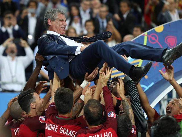 Portugal's coach Fernando Santos is held up by his players as they celebrate after beating France during the Euro 2016 final football match at the Stade de France in Saint-Denis. (AFP Photo) Portugal's coach Fernando Santos is held up by his players as they celebrate after beating France during the Euro 2016 final football match at the Stade de France in Saint-Denis. (AFP Photo)