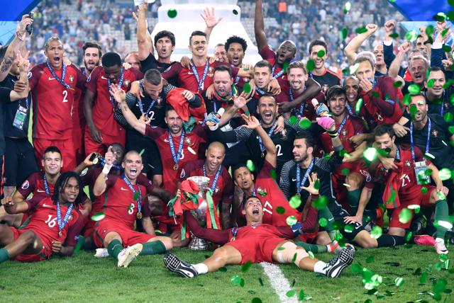 Portugal's players pose with the trophy as they celebrate after beating France during the Euro 2016 final football match at the Stade de France in Saint-Denis, north of Paris. (AFP Photo) Portugal's players pose with the trophy as they celebrate after beating France during the Euro 2016 final football match at the Stade de France in Saint-Denis, north of Paris. (AFP Photo)
