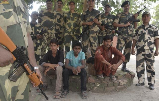 BSF jawans holding the intruders captive at Ajnala near Indo-Pak border, Amritsar on Tuesday. (Sameer Sehgal/HT Photo)