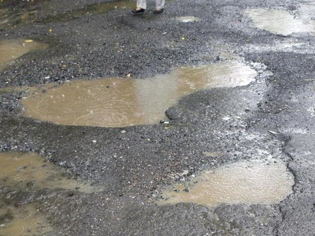 Mumbai, India - June 20, 2015 : Monsoon comes with the usual problems of potholes, causing inconvenience to commuters,Malad, in Mumbai, India on Saturday, June 20, 2015. (Photographs by - Vidya Subramanian/Hindustan Times) (Hindustan Times) Mumbai, India - June 20, 2015 : Monsoon comes with the usual problems of potholes, causing inconvenience to commuters,Malad, in Mumbai, India on Saturday, June 20, 2015. (Photographs by - Vidya Subramanian/Hindustan Times) (Hindustan Times)