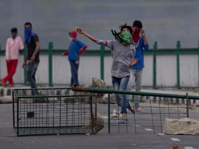 Kashmiri Muslim protesters throw stones at Indian troops in Srinagar. (AP Photo) Kashmiri Muslim protesters throw stones at Indian troops in Srinagar. (AP Photo)