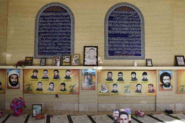 Portraits of late Hezbollah senior military commanders and fighters who were killed during fighting with Israel in 2006 war and in Syria, hang on a wall at a cemetery in the southern village of Aynata, close to the town of Bint Jbail, Lebanon. (AP) Portraits of late Hezbollah senior military commanders and fighters who were killed during fighting with Israel in 2006 war and in Syria, hang on a wall at a cemetery in the southern village of Aynata, close to the town of Bint Jbail, Lebanon. (AP)