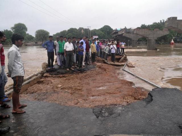 People wade through a flooded road in Vidisha on Tuesday. (Piyush Malviya/HT photo) People wade through a flooded road in Vidisha on Tuesday. (Piyush Malviya/HT photo)