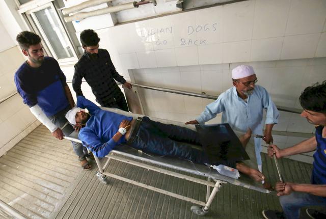People carry a man with eye injuries to a local hospital in Srinagar. Apart from the 17 patients with bullet injuries, SMHS Hospital has also treated more than 77 people with eye injuries due to pellets. (Waseem Andrabi / HT Photo) People carry a man with eye injuries to a local hospital in Srinagar. Apart from the 17 patients with bullet injuries, SMHS Hospital has also treated more than 77 people with eye injuries due to pellets. (Waseem Andrabi / HT Photo)