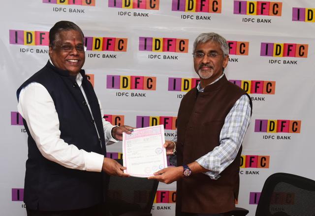 From R – L: Dr. Rajiv Lall, Founder MD & CEO of IDFC Bank with Mr. S. Devaraj, Chairman & MD of Grama Vidiyal Micro Finance Ltd. exchanging documents after the acquisition in Mumbai on Tuesday.(HT Archive)